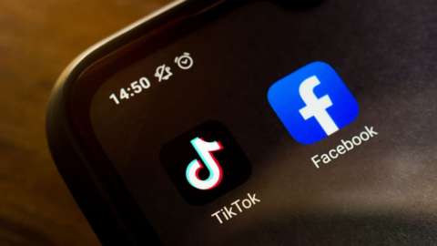 TikTok Facebook logos on a phone screen