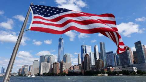 USA flag with NYC skyline behind