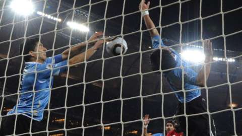 Luis Suarez handles the ball on the line during the Uruguay-Ghana World Cup quarter-final in 2010