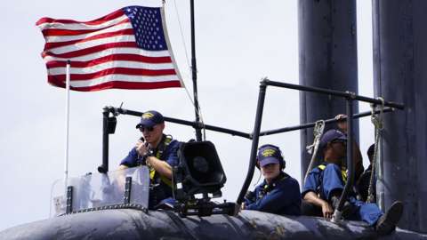 Sailors assigned to the Los Angeles-class attack submarine USS Albuquerque SSN 706 stand watch as the boat departs Diego Garcia in 2015