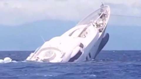 A luxury yacht sinking into the Mediterranean Sea