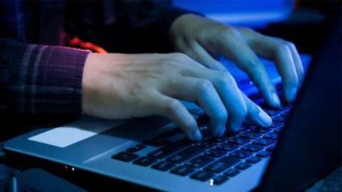 Stock image of hands typing on a keyboard