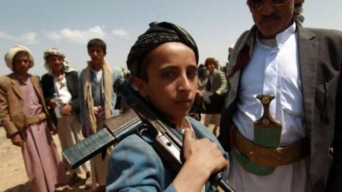 An armed Yemeni boy loyal to the Houthi movement at a tribal gathering in Bani al-Harith, north of Sanaa (17 August 2014)