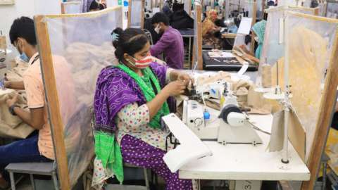 A woman manufactures clothes in a textile factory in the Gazipur industrial zone on the outskirts of Dhaka