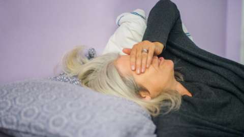Woman who is tired lying in bed