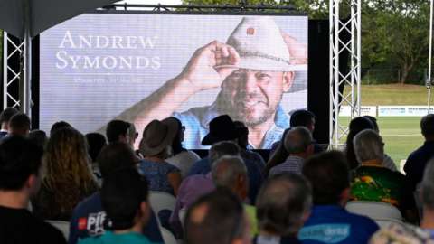 Video screen showing Andrew Symonds at his public memorial service