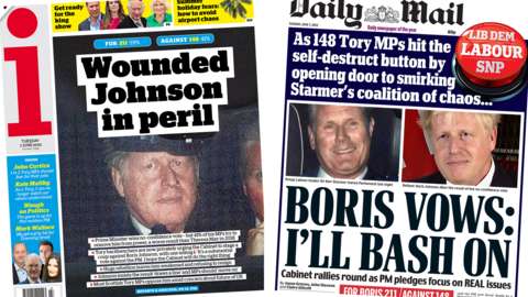 The headline in the i reads, "Wounded Johnson in peril", while the headline in the Mail reads, "Boris vows: I'll bash on"