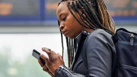 Stock image of a woman with a mobile phone travelling