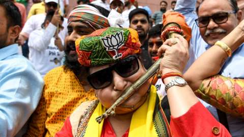 A female BJP supporter celebrates