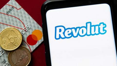 Revolut logo with euro coins and banking card