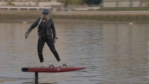 Olympian Aimee Fuller on an electric surfboard on the Thames
