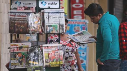 Man reads papers announcing Lenin Moreno's victory in the 2017 presidential elections