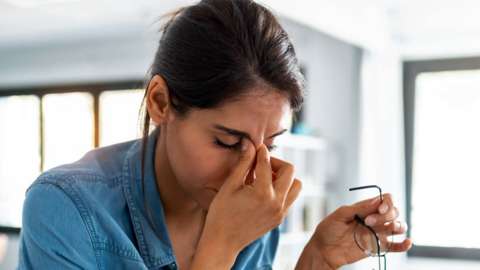 Stock image of a woman looking tired
