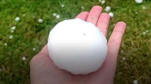 A giant hailstone in someone's palm
