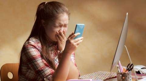 A young girl upset by something she has seen online