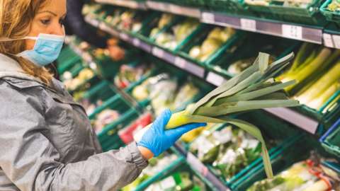 Woman looking at fruit and veg in store