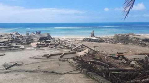 A view of debris and broken structures on a beach
