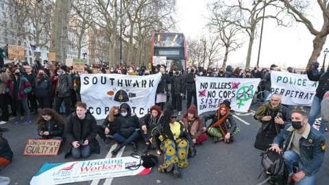 Protesters stand in the road Scotland Yard