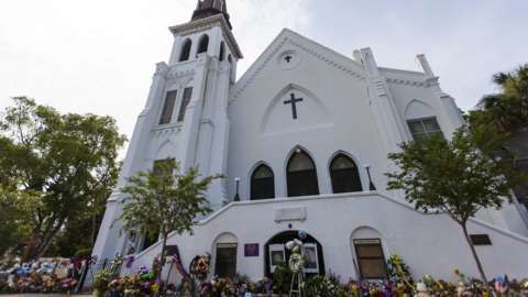Flowers and memorial items line the front of Emanuel African Methodist Episcopal Church, Charleston, South Carolina. Photo: 25 June 2015