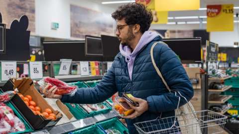 Stock image of a man shopping for food