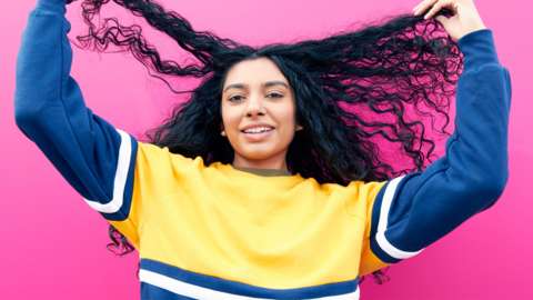 Girl holding her hair