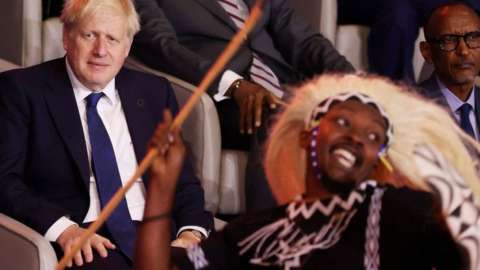Britain's Prime Minister Boris Johnson (L) and Rwanda's President Paul Kagame look on as dancers perform during the opening ceremony of the Commonwealth Heads of Government Meeting at Kigali Convention Centre in Kigali, on June 24, 2022