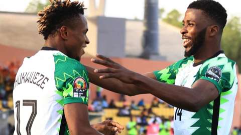 Samuel Chukwueze celebrates a goal with Nigeria forward Kelechi Iheanacho