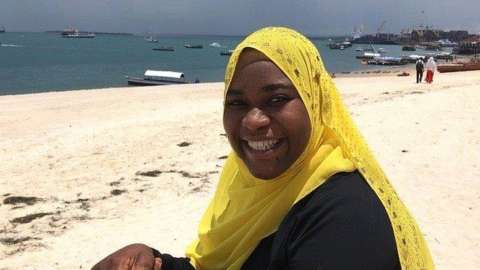 Khadija Abdulla Ali sitting on beach