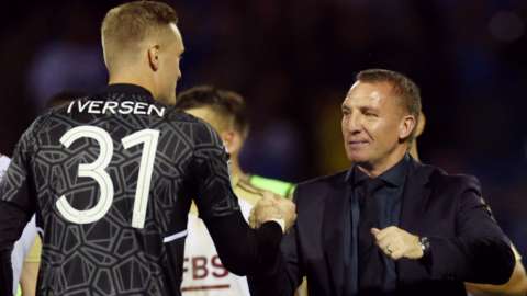Goalkeeper Daniel Iversen with manager Brendan Rodgers