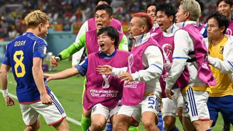 Japan celebrate their equaliser against Spain