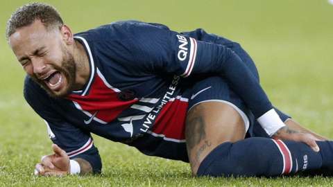 Neymar reacts after being injured during Paris St-Germain's game with Lyon in Ligue 1