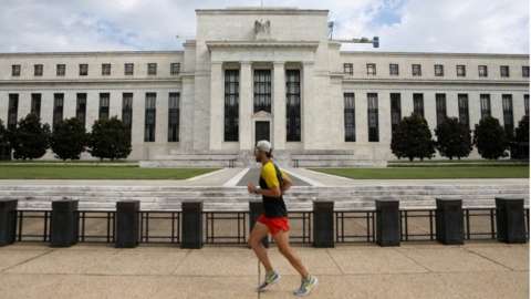 A jogger runs past the Federal Reserve building in Washington, DC, U.S., August 22, 2018.