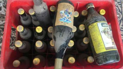 Bottles of beer, wine and olive oil in a crate