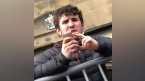 Alfie McIntosh outside court with a phone and cigarette
