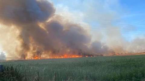 Fire in crop field at Springbottom Farm, near Wilsford
