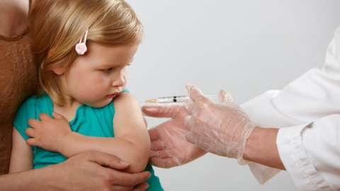 A toddler being vaccinated