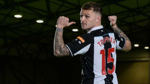 Kieran Trippier points at his name on the back of his Newcastle shirt