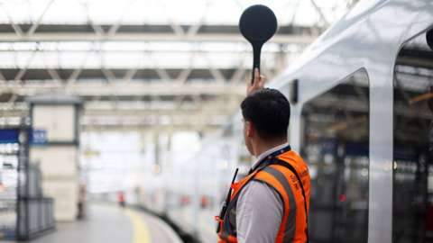 Train conductor at Waterloo Station, 23 June 2022