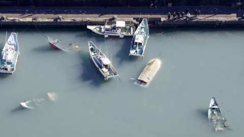 Capsized boats believed to be affected by the tsunami after an underwater volcano eruption are seen in Muroto, Kochi prefecture, Japan. Photo: 16 January 2022