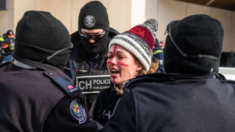 Police arrest a demonstrator against Covid-19 mandates in Ottawa on February 18, 2022.
