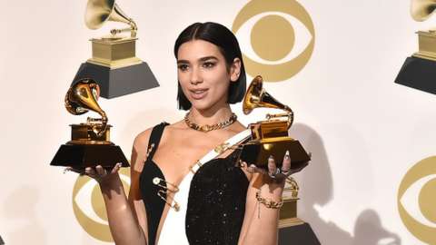 Dua Lipa holds trophies at the 2019 Grammy Awards