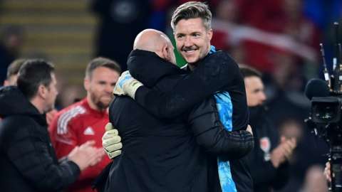 Wayne Hennessey embraces Robert Page