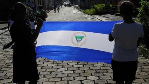 Two women carry a Nicaraguan flag during an anti-government protest in Masay