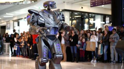 Titan, a robot created by Cyberstein Robots Ltd., performs during a promotional event at the Qwartz shopping centre in Villeneuve-la-Garenne, near Paris