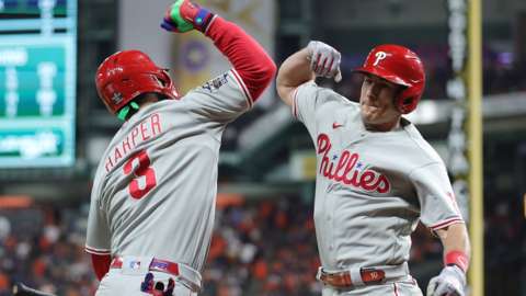 Philadelphia Phillies' Bryce Harper and JT Realmuto celebrate the latter's 10th-inning home tun