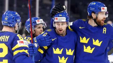 Sweden players celebrate a goal against Great Britain at the Ice Hockey World Championship