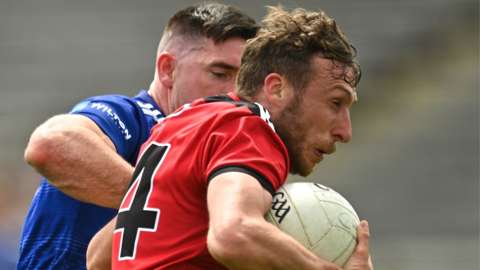 Cavan's Killian Brady challenges Down opponent Barry O'Hagan