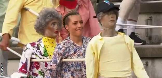 Dancers in the stands with dolls
