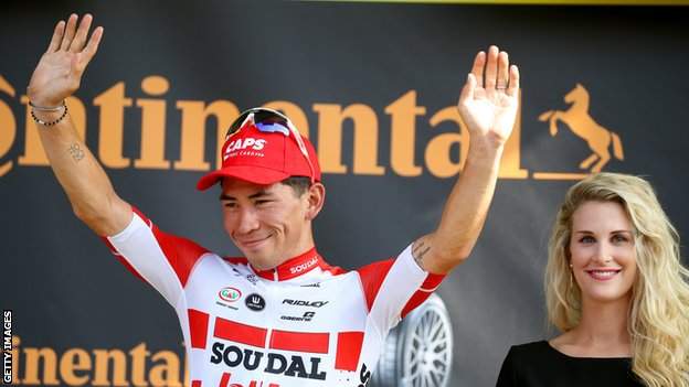 Caleb Ewan waves on the podium after winning stage 16