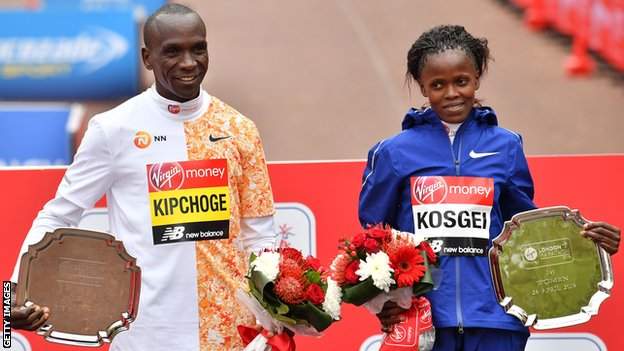 2019 London Marathon winners Eliud Kipchoge (left) and Brigid Kosgei (right) pose with their trophies